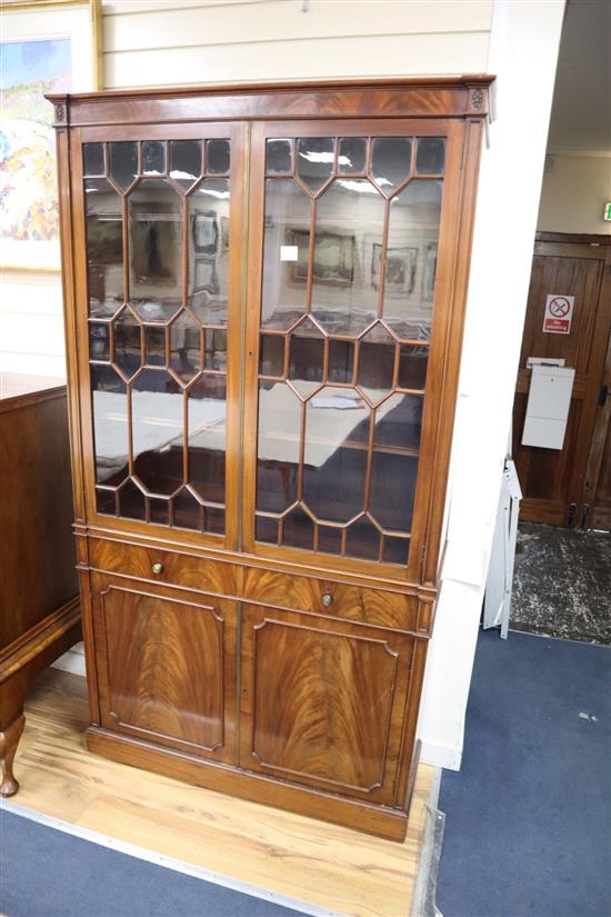 A George III style mahogany bookcase cupboard, width 106cm, depth 33cm, height 200cm